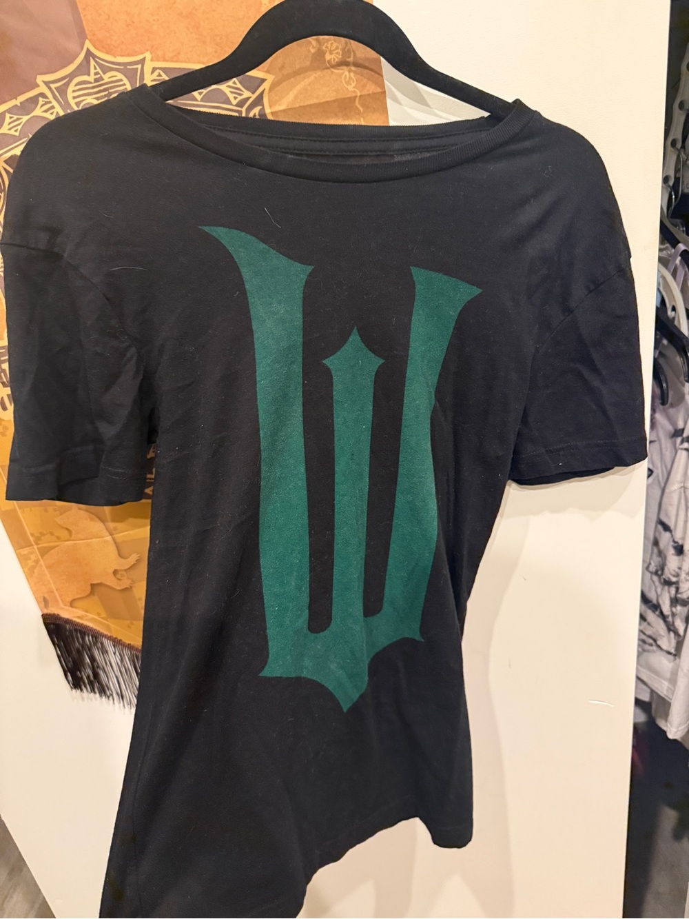 Universal Black Short-Sleeve Tee with Green Crest Graphic